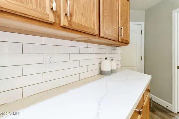 a kitchen with a sink cabinets stainless steel appliances and a counter top space