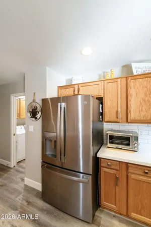 a kitchen with stainless steel appliances granite countertop a refrigerator and a stove top oven