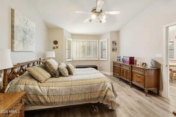 a bedroom with a bed and wooden floor