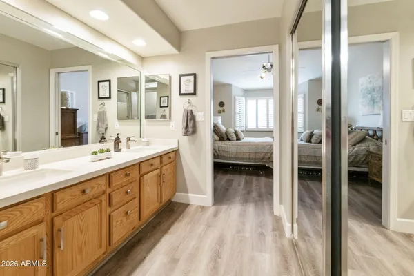 a spacious en suite bathroom with a double vanity sink and a mirror