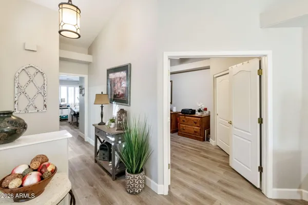 a hallway with wooden floor and furniture