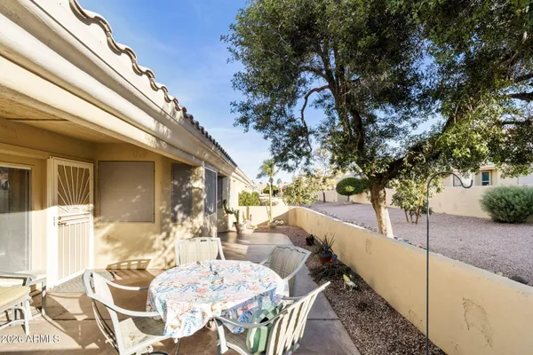 a view of a patio with table and chairs and potted plants