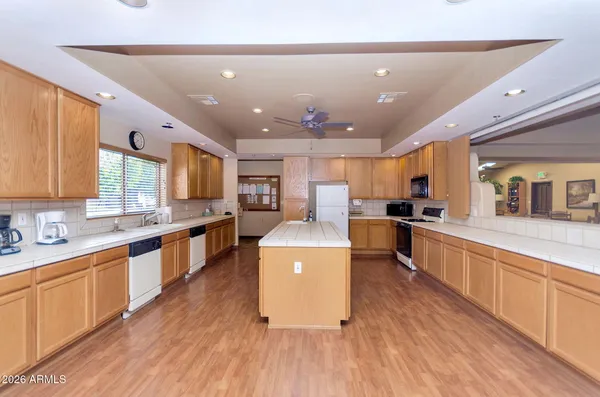 a large kitchen with stainless steel appliances lots of counter space and a sink