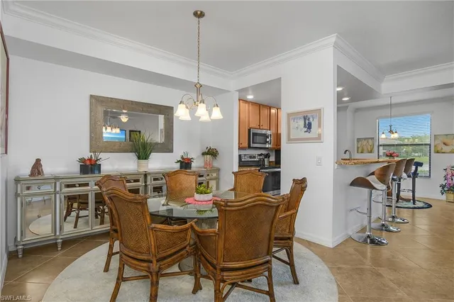a view of a dining room with furniture and a chandelier