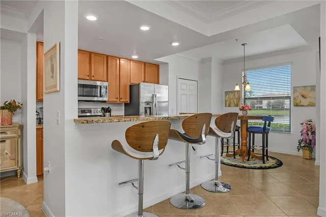 a kitchen with stainless steel appliances granite countertop a sink a stove and a refrigerator