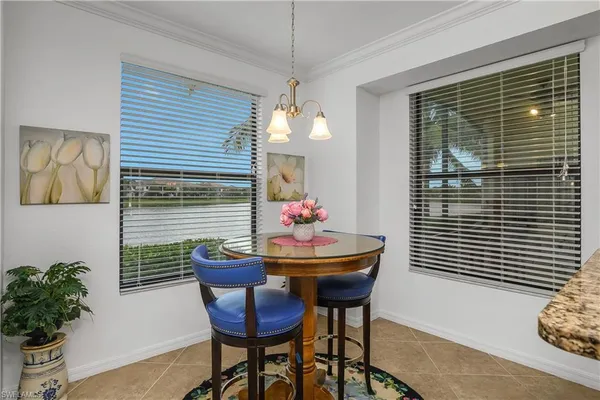 a dining room with furniture and a window