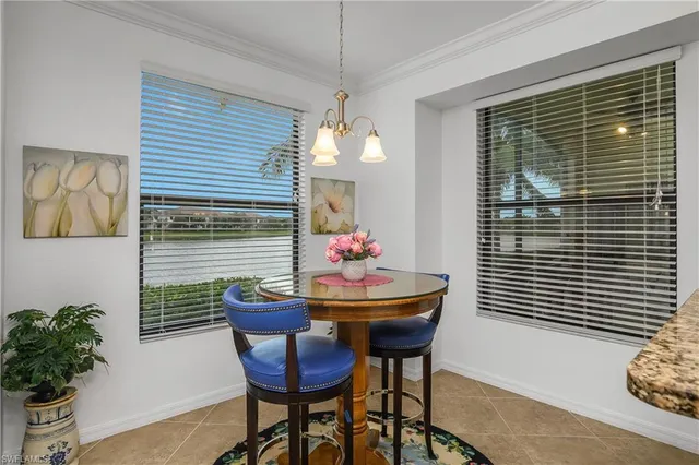 a dining room with furniture and a window