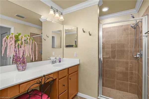 a bathroom with a granite countertop sink a large mirror and shower