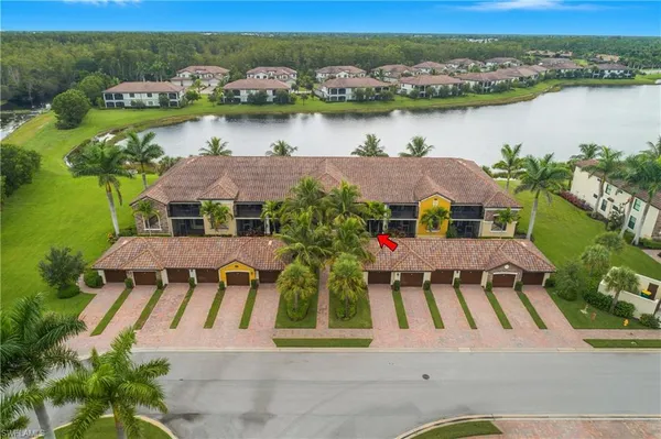 an aerial view of residential houses with outdoor space and river