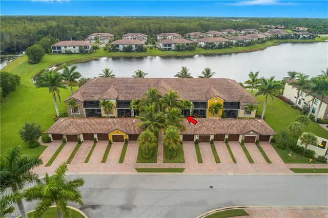 an aerial view of residential houses with outdoor space and river