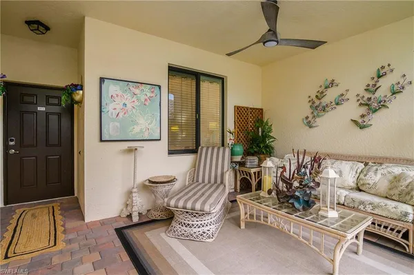 a living room with furniture flowerpot and window