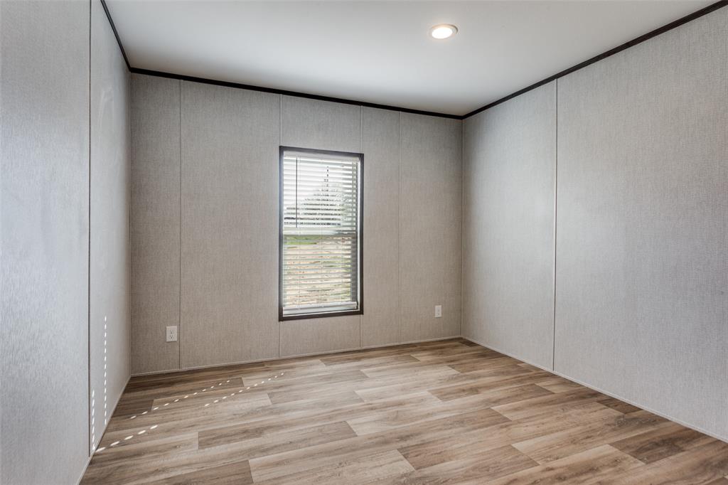 175 Cedar Drive Azle, TX 76020 - Photo 22 of 25 an empty room with wooden floor and windows
