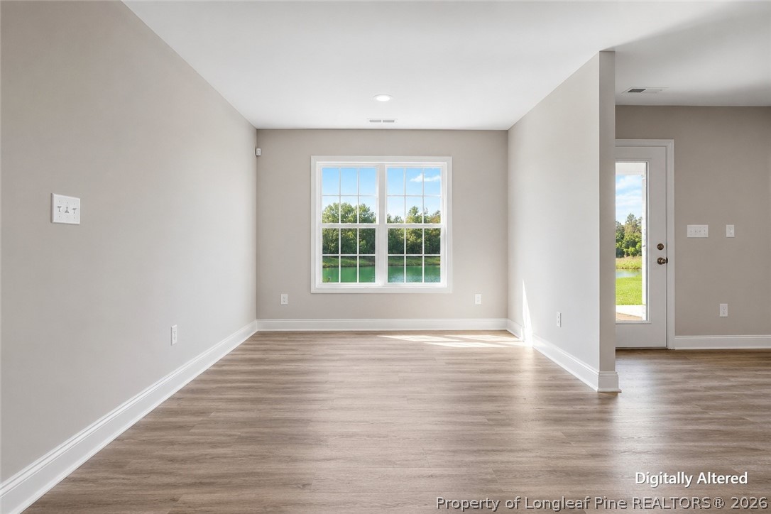 756 Jordan Road Autryville, NC 28318 - Photo 20 of 34 a view of an empty room with window and wooden floor