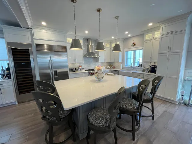 a large kitchen with a table and chairs