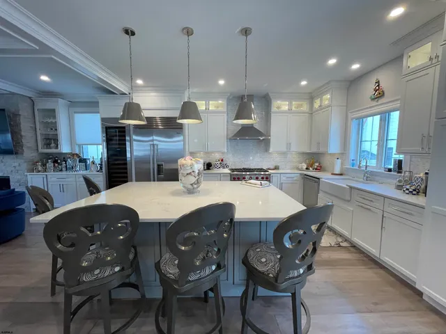 a large kitchen with a table and chairs