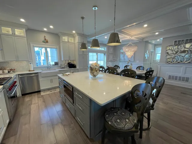 a kitchen with a stove a counter space a sink dishwasher and wooden cabinets