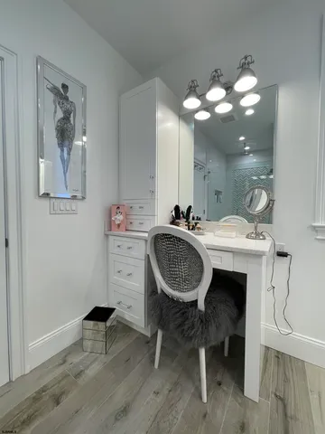 a bathroom with a sink a light fixture and a mirror