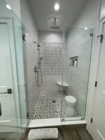 a spacious bedroom with a bed a table and chair