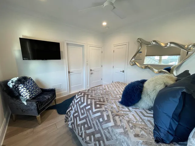 a bathroom with a toilet sink vanity granite and shower