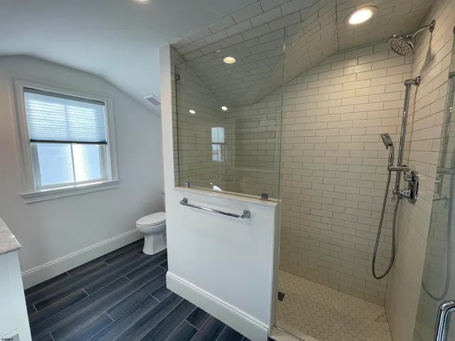 a bedroom with a bed tv and chair