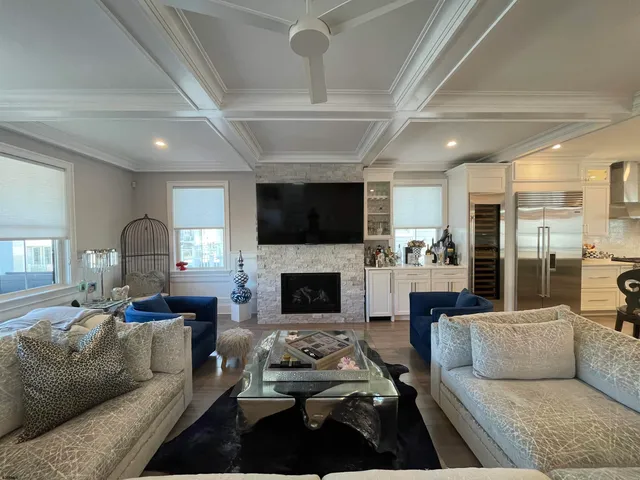 a living room with furniture flat screen tv and a fireplace