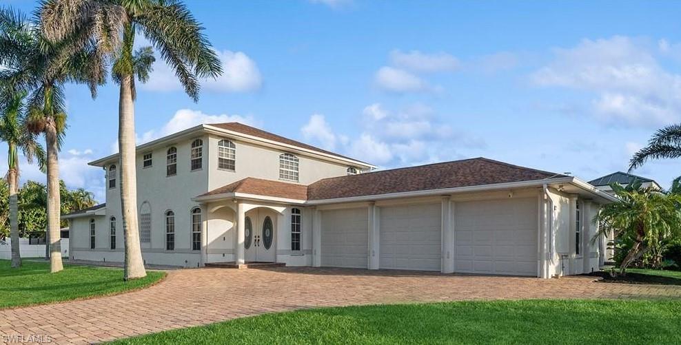 10082 Vanderbilt Drive Naples, FL 34108 - Photo 1 of 43 a front view of a house with a yard and garage