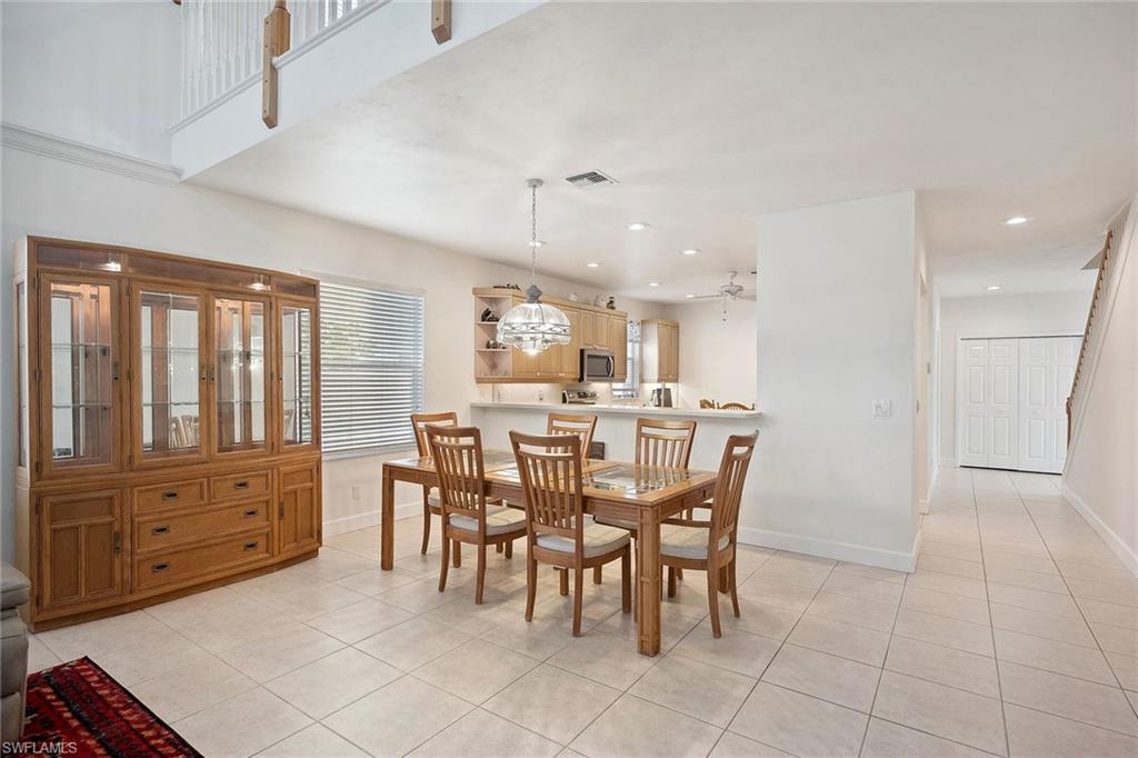 10082 Vanderbilt Drive Naples, FL 34108 - Photo 14 of 43 a dining area with furniture and window