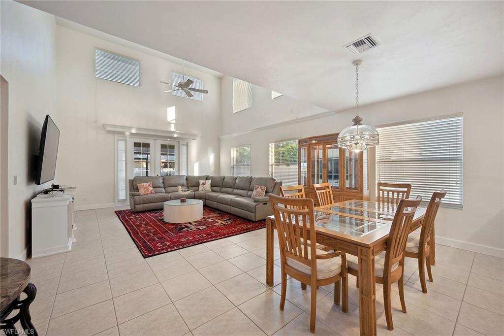 10082 Vanderbilt Drive Naples, FL 34108 - Photo 15 of 43 a dining room with furniture and wooden floor
