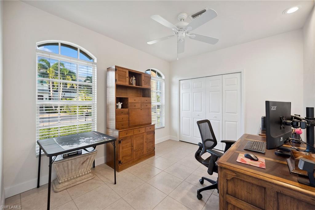 10082 Vanderbilt Drive Naples, FL 34108 - Photo 17 of 43 a room with furniture and a window