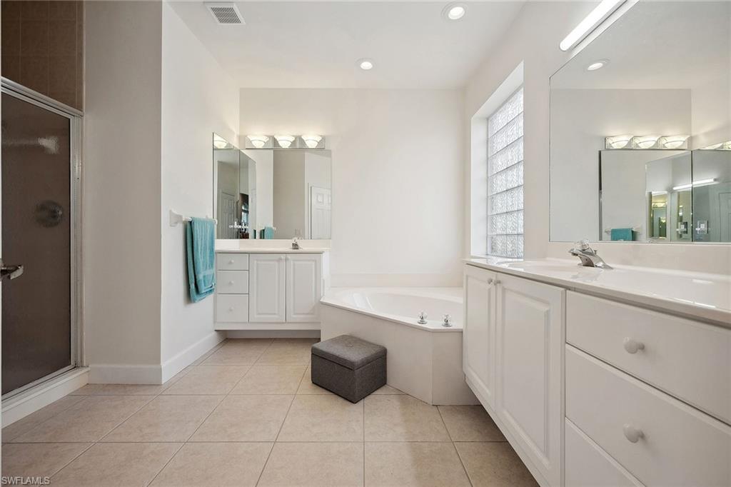 10082 Vanderbilt Drive Naples, FL 34108 - Photo 20 of 43 a bathroom with a sink vanity and mirror