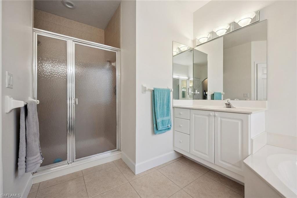 10082 Vanderbilt Drive Naples, FL 34108 - Photo 21 of 43 a bathroom with a double vanity sink and mirror