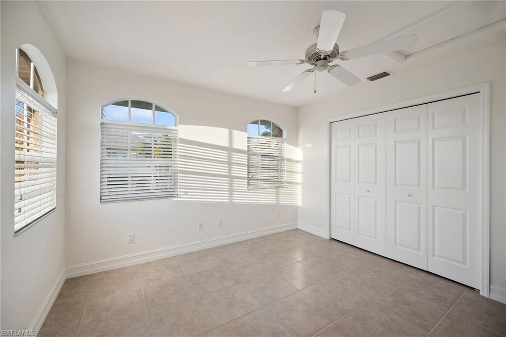 10082 Vanderbilt Drive Naples, FL 34108 - Photo 24 of 43 a view of an empty room with a window