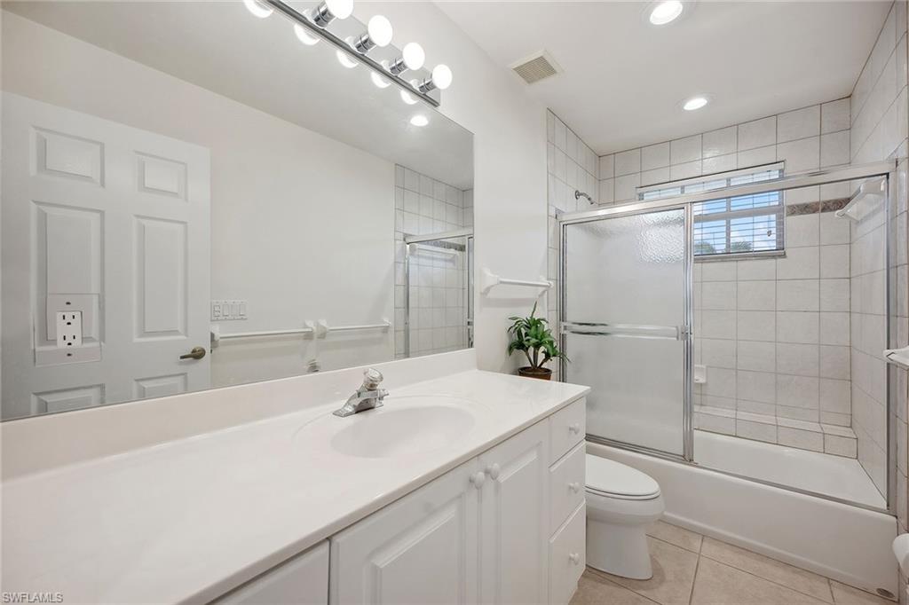 10082 Vanderbilt Drive Naples, FL 34108 - Photo 27 of 43 a bathroom with a sink a toilet and shower