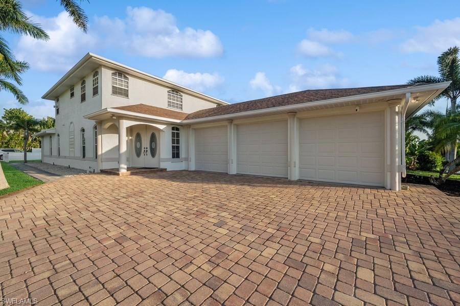10082 Vanderbilt Drive Naples, FL 34108 - Photo 3 of 43 a front view of a house with a yard