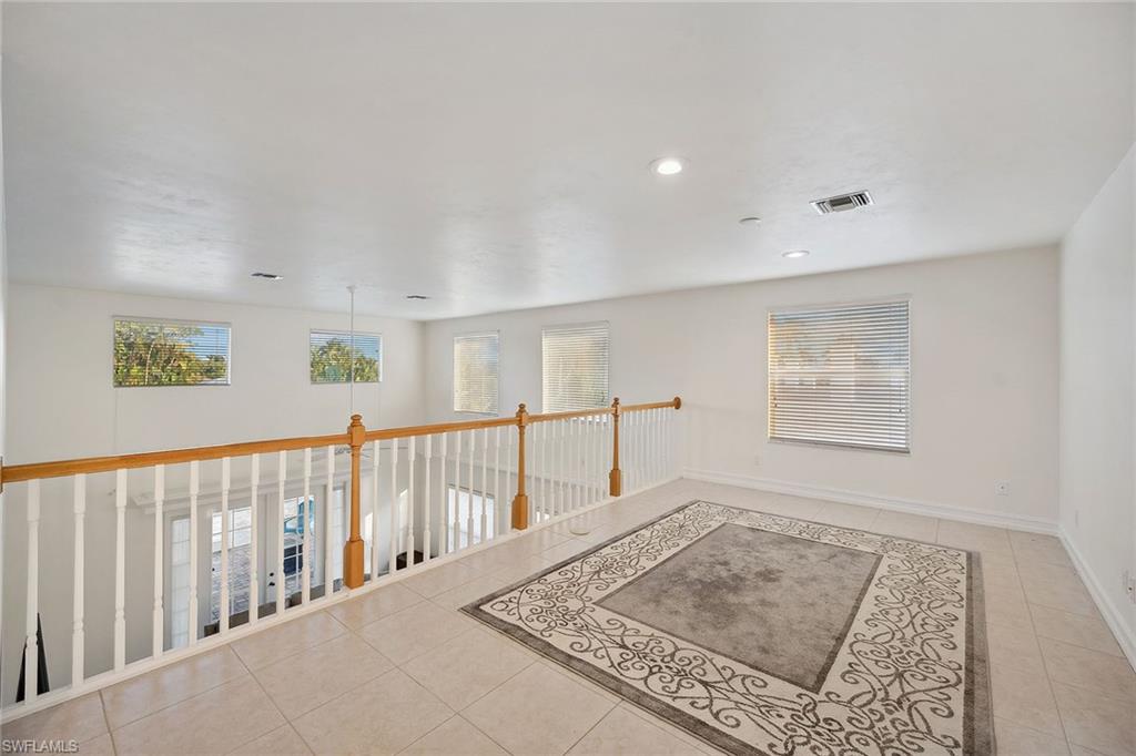 10082 Vanderbilt Drive Naples, FL 34108 - Photo 32 of 43 a view of hallway with a window