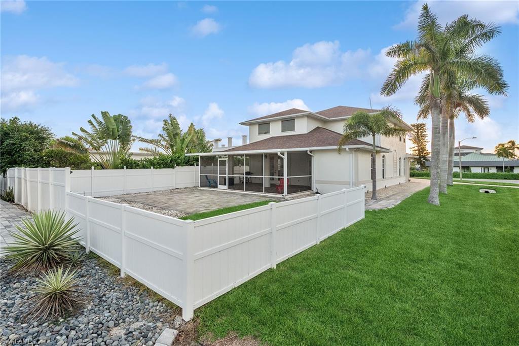 10082 Vanderbilt Drive Naples, FL 34108 - Photo 36 of 43 a view of a house with a backyard