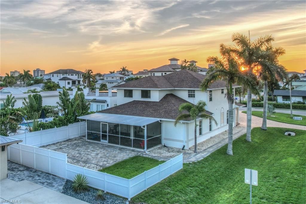 10082 Vanderbilt Drive Naples, FL 34108 - Photo 38 of 43 a view of a house with a yard and sitting area