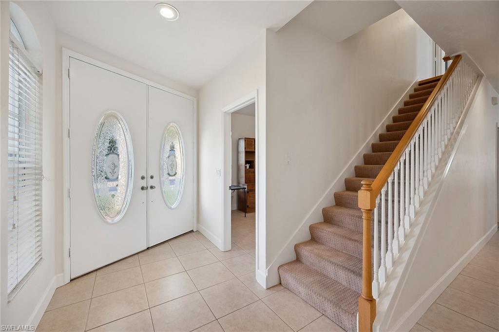 10082 Vanderbilt Drive Naples, FL 34108 - Photo 5 of 43 a view of a hallway with entryway and stairs