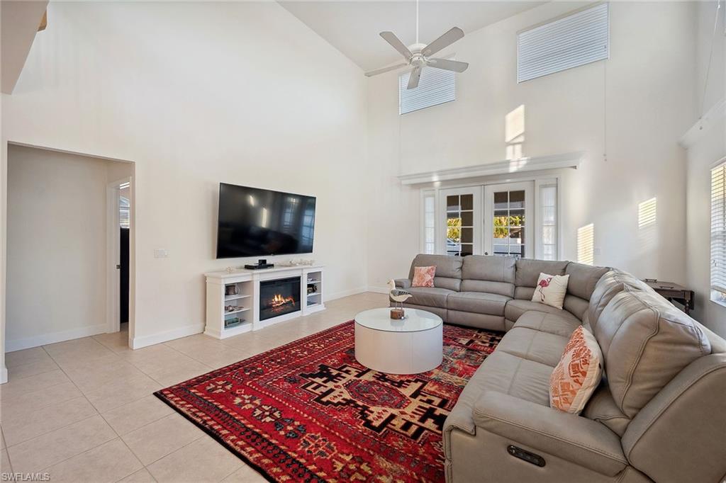 10082 Vanderbilt Drive Naples, FL 34108 - Photo 6 of 43 a living room with furniture and a flat screen tv