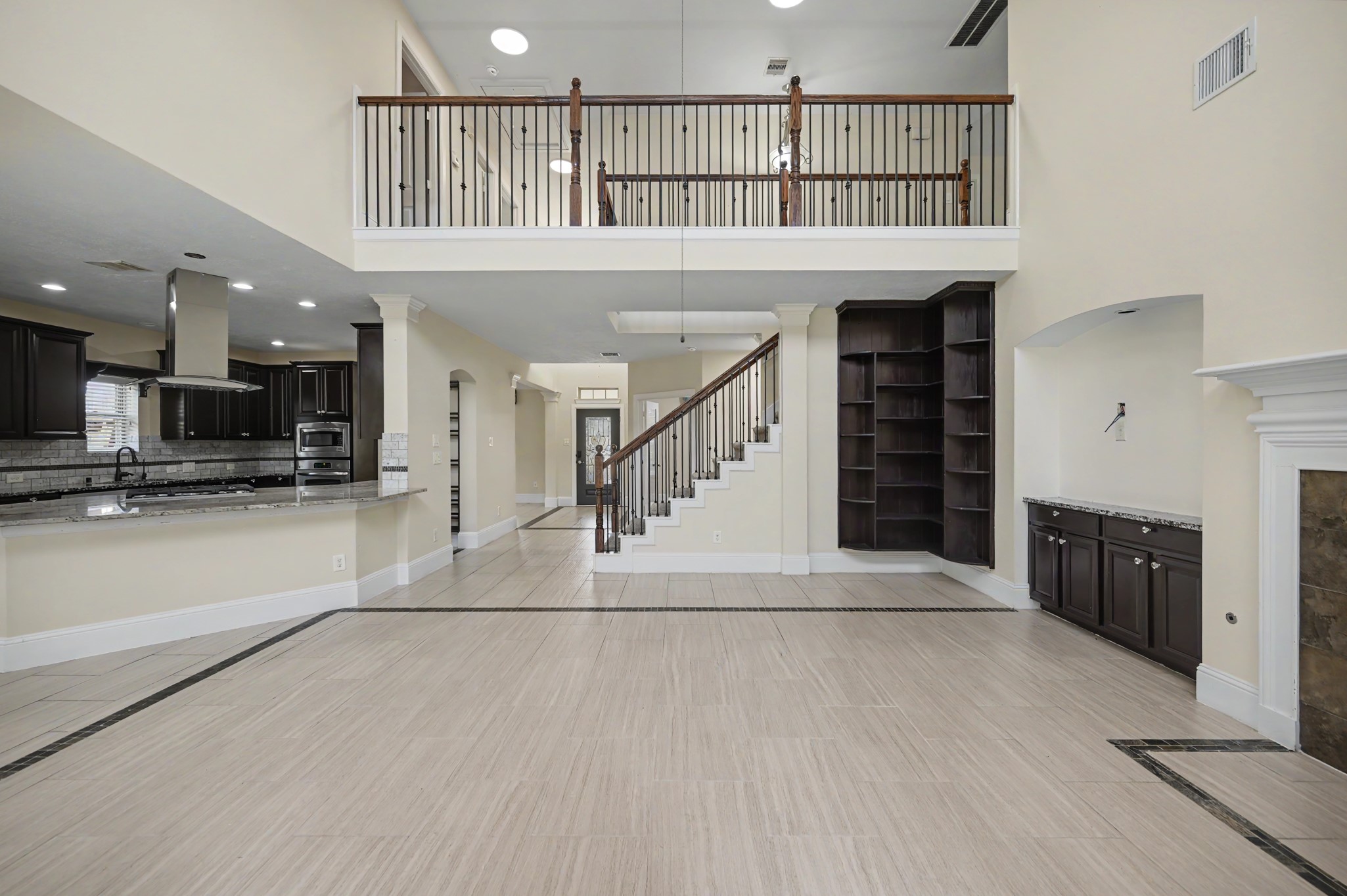 31325 Riley Woods Court Spring, TX 77386 - Photo 16 of 50 Designed to feel connected from every angle, the main living area brings together the kitchen, fireplace, staircase and second floor overlook in one impressive space.