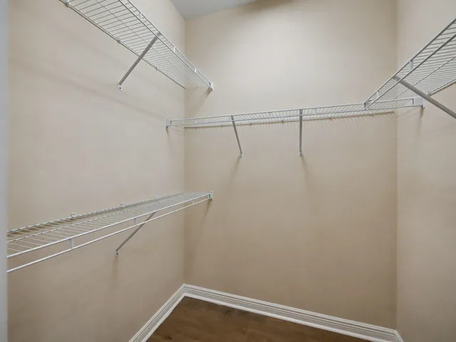 en empty room with windows and fan