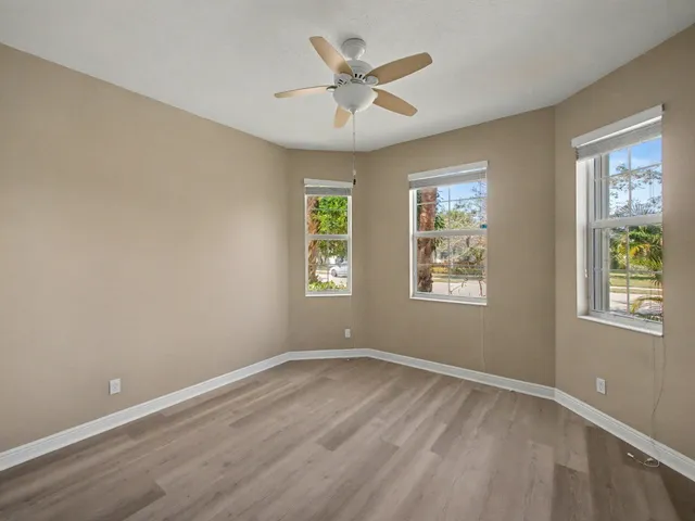 a view of an empty room and a ceiling fan