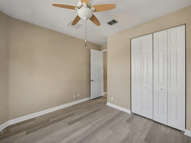 a view of a livingroom with a ceiling fan and window