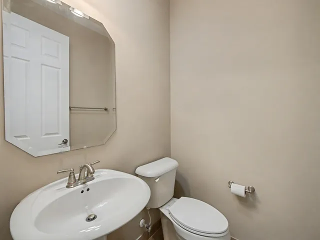 an aerial view of residential houses with outdoor space and parking