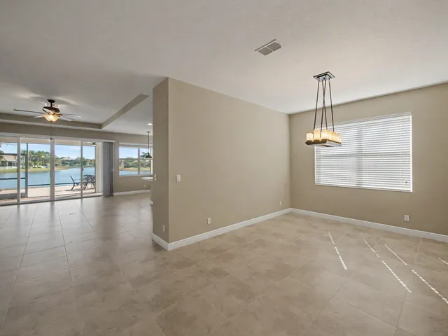 a view of an empty room with a ceiling fan