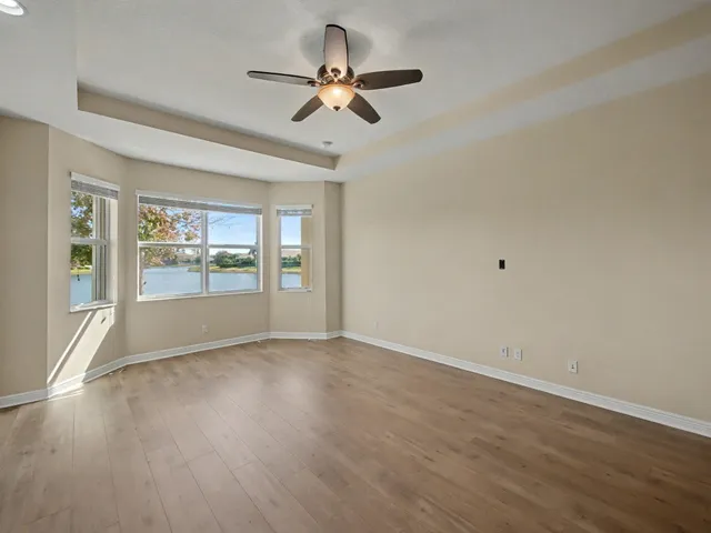 a large kitchen with a sink and refrigerator
