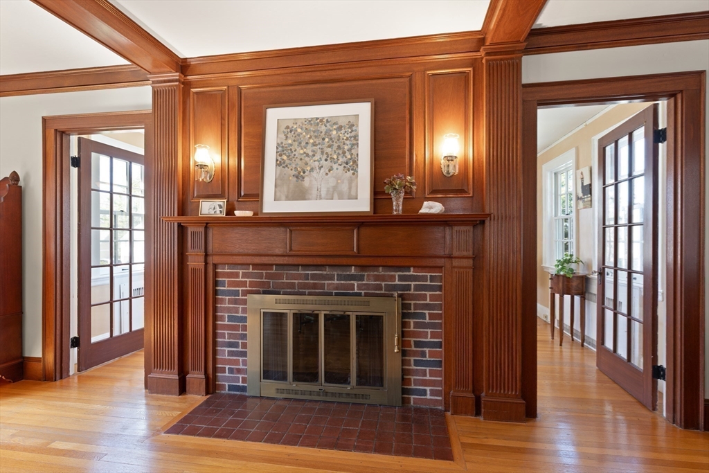 2 Plymouth Road Lexington, MA 02421 - Photo 12 of 38 a living room with a fireplace and wooden floor