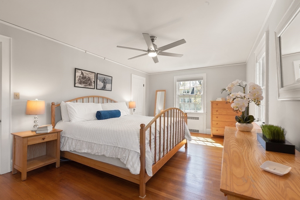 2 Plymouth Road Lexington, MA 02421 - Photo 19 of 38 a bedroom with a bed and wooden floor