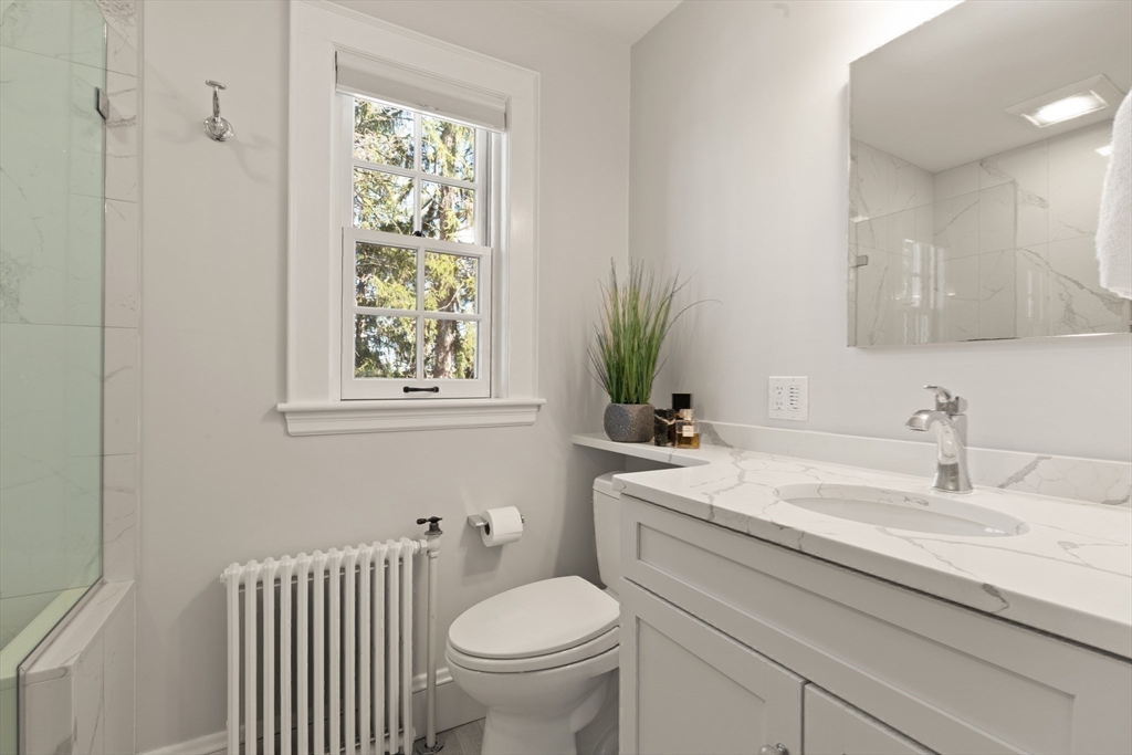 2 Plymouth Road Lexington, MA 02421 - Photo 20 of 38 a bathroom with a granite countertop toilet sink and mirror