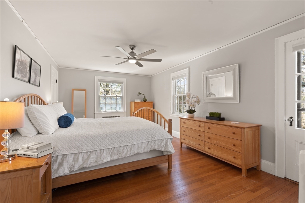 2 Plymouth Road Lexington, MA 02421 - Photo 21 of 38 a bedroom with a large bed and a chandelier